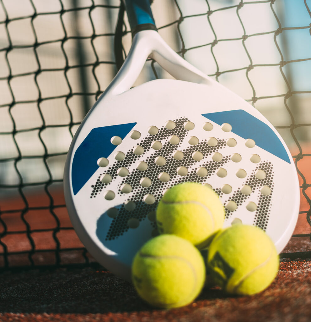 Padel blade racket resting on the net